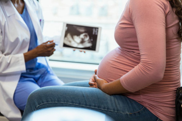 doctor and patient reviewing ultrasound-GettyImages-1334856826