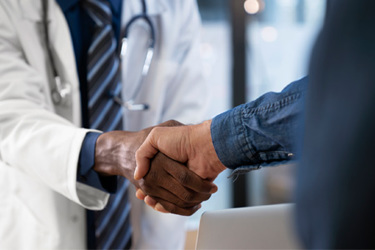 Doctor Shaking Patient's Hand GettyImages-1684218936