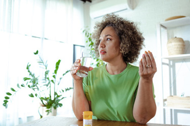 Woman taking medications-GettyImages-1782441970