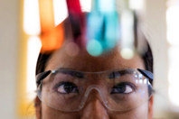 Scientist observing colorful liquid in test tubes-GettyImages-2158013158