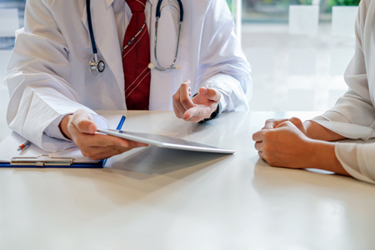 iStock-1232630835-patient-doctor-tablet