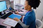 Nurse-sitting-at-desk-GettyImages-1394002689