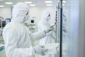 GettyImages-1087218908 In the Manufacturing Facility Team of Scientists Wearing Sterile Protective Coverall