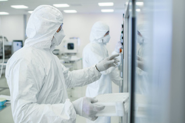 GettyImages-1087218908 In the Manufacturing Facility Team of Scientists Wearing Sterile Protective Coverall