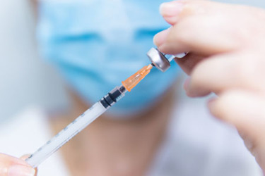 GettyImages-1371993517-syringe-vial-mask-vaccine-inject