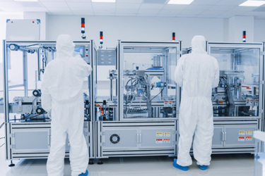 GettyImages-1087219020 Scientists wearing protective coveralls working in manufacturing laboratory