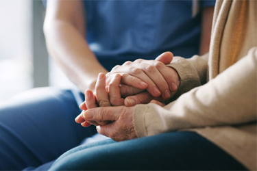 GettyImages-1165981632-holding-hands-nurse-patient GettyImages-1165981632-holding-hands-nurse-patient