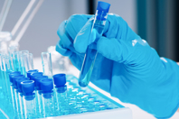 GettyImages-1310126023-test-tube-vaccine-lab-glove