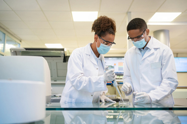 GettyImages-1371707479-lab-mask-team-partnership