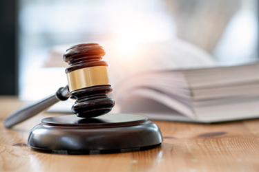 GettyImages-1411630763 Wooden Judge Gavel On A Table