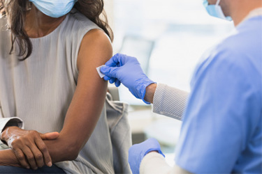 Doctor Preparing Injection Site GettyImages-1379313214