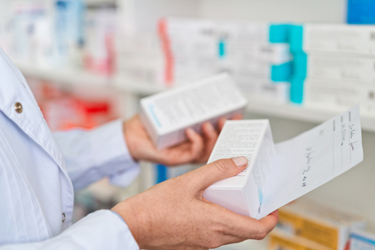 pharmacist holding medicine-GettyImages-1475020277