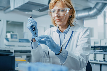 Scientist laboratory pipette GettyImages-1140779660