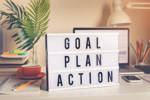 Goal,plan,action text on light box on desk table