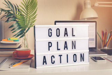 Goal,plan,action text on light box on desk table