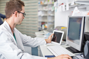Pharmacist working at desk-GettyImages-537315268
