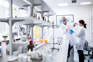 Scientists Mixing Solution In Lab GettyImages-1443286944