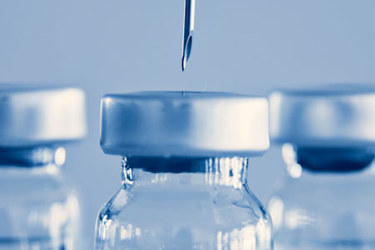 GettyImages-1311494510-vaccine-bottle-needle